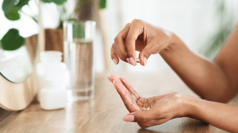 Woman's hands holding vitamins