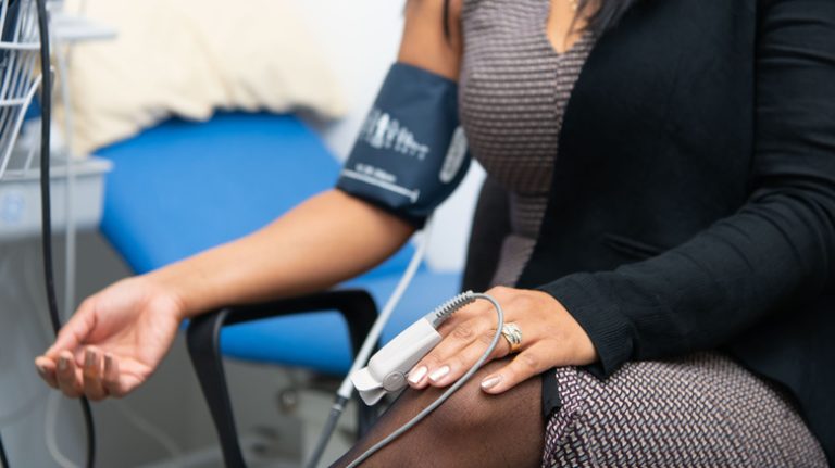 woman wearing blood pressure cuff