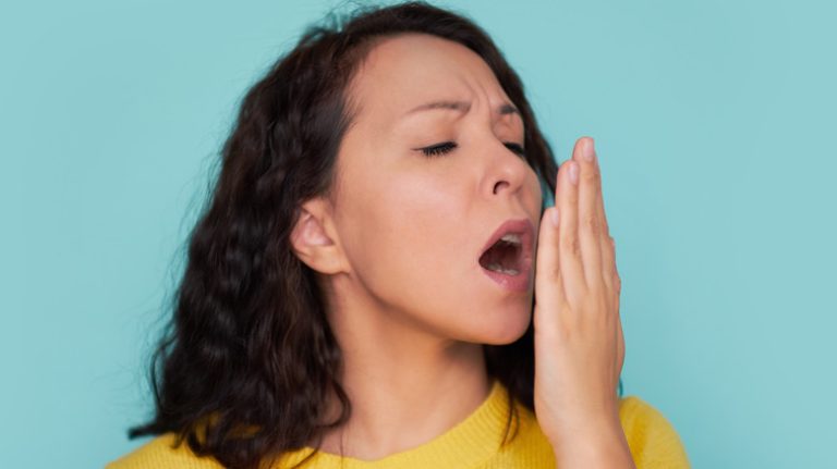 woman covering mouth