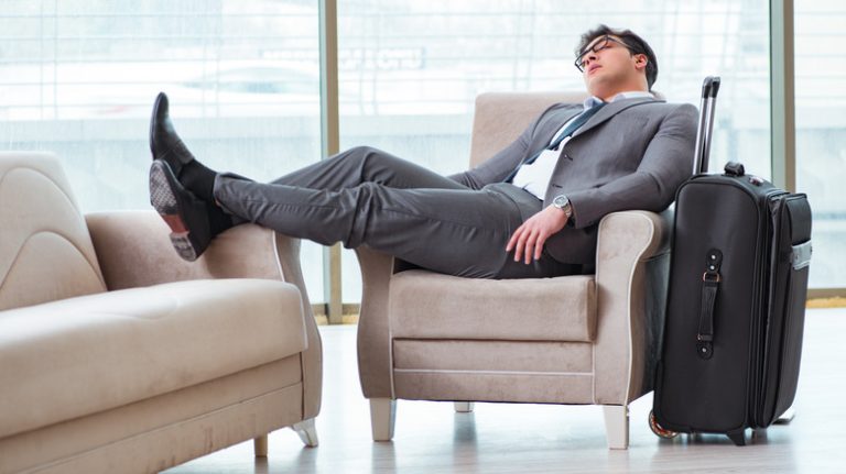 a business man asleep at the airport