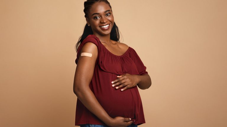 Pregnant woman holding belly