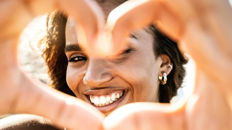 Woman making heart with hands