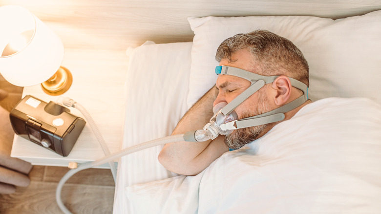 man sleeping with cpap machine