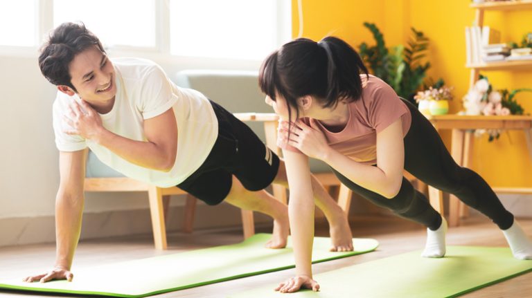 Asian couple working out together