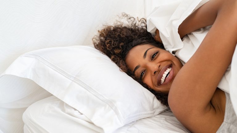 a woman waking up happy