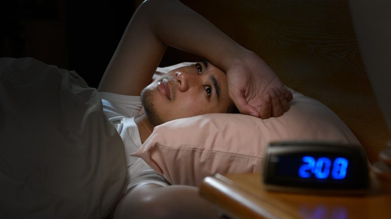 Man laying awake in bed