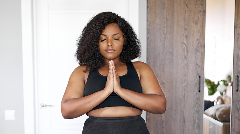 A woman practices meditation and yoga