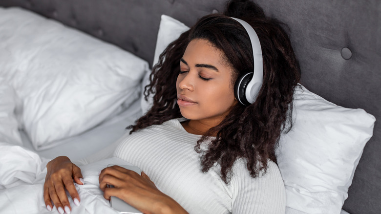 Young woman sleeping with headphones on