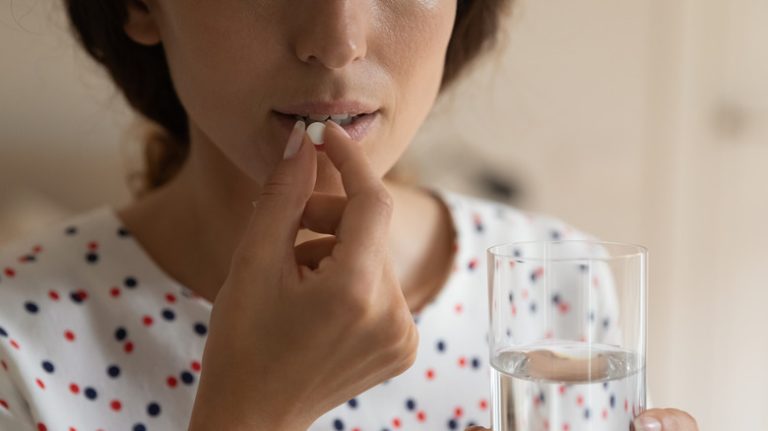 woman taking pill