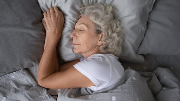 Older woman sleeping on side