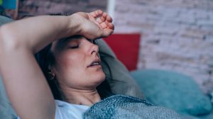 woman having trouble sleeping from heat