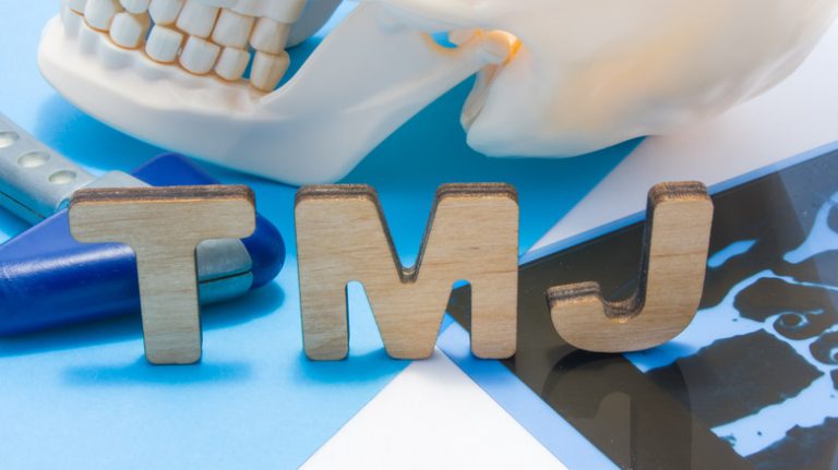 Letters TMJ and plastic skull