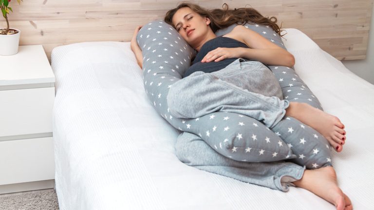 Woman sleeping with pillow between her knees