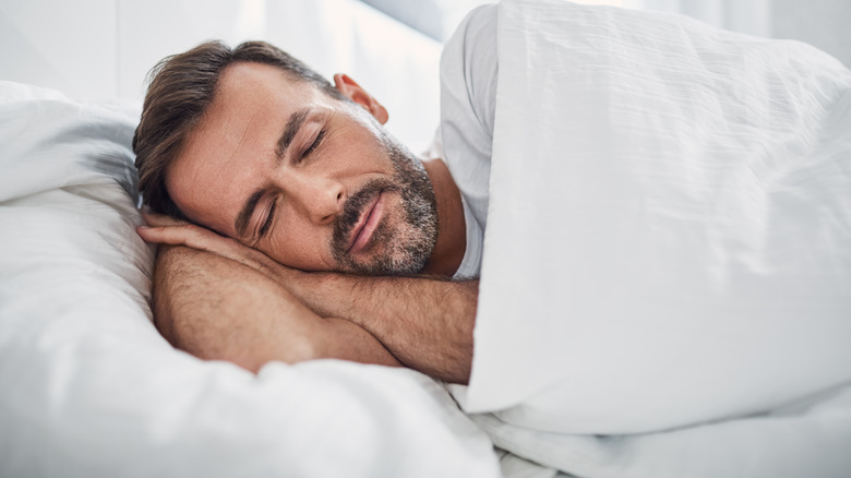 man sleeping in bed