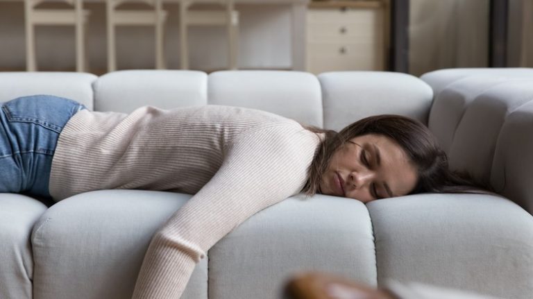 A woman naps on the couch