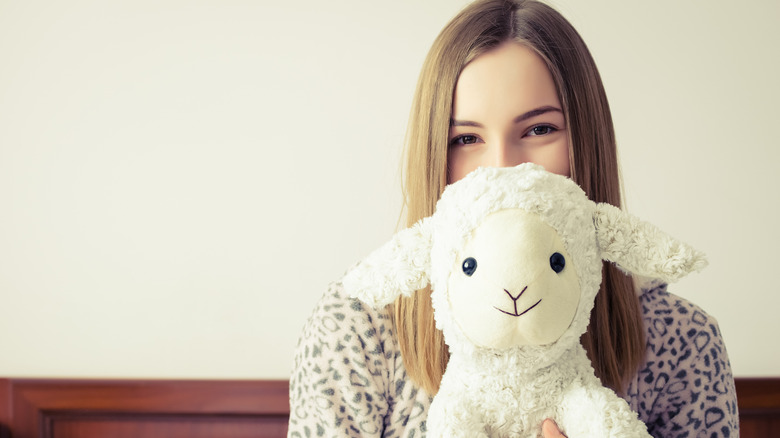 Woman holding stuffed animal