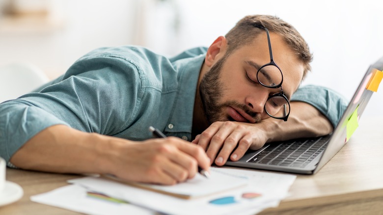 man falling asleep at computer