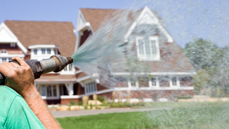 Person hydroseeding a lawn