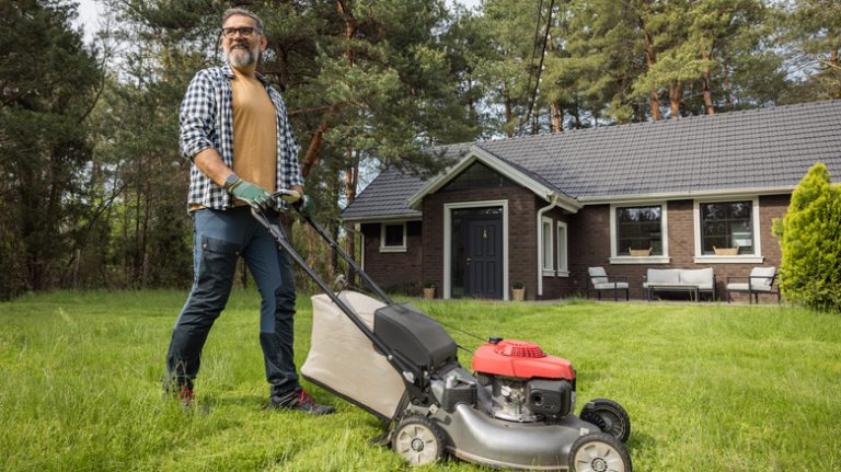 Man mowing his backyard lawn