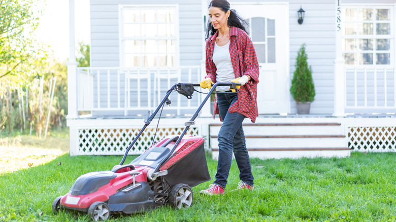 Woman mowing lawn