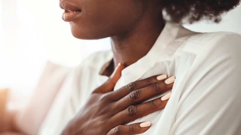 woman with her hand over her heart