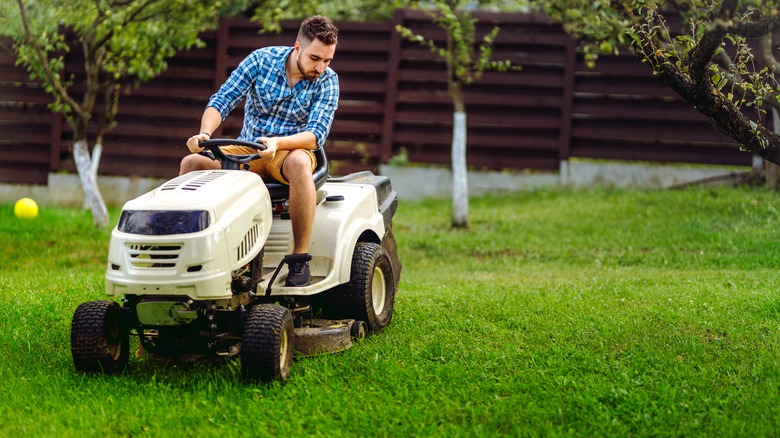 Person mowing with lawn tractor
