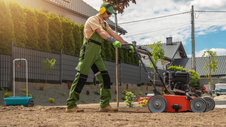 man pushing orange aerator