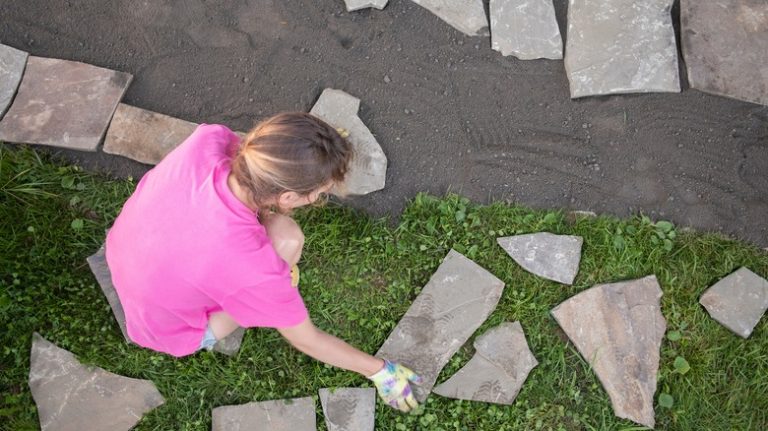 person laying pavers