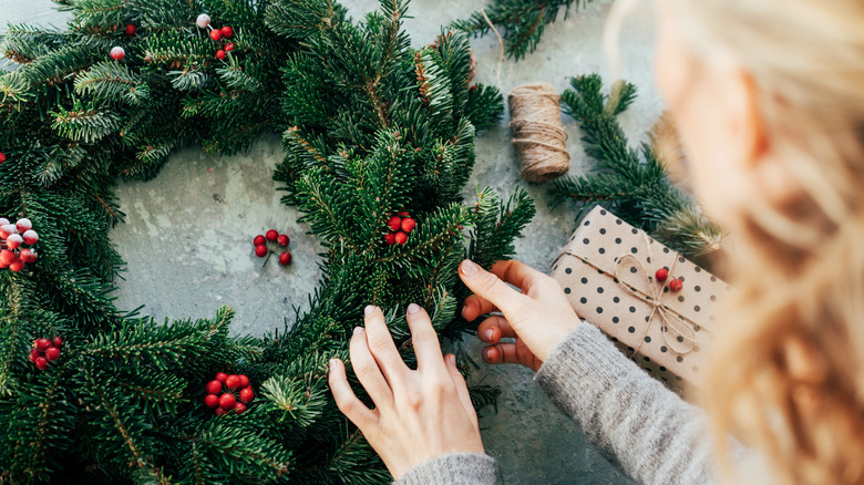 person making natural wreath