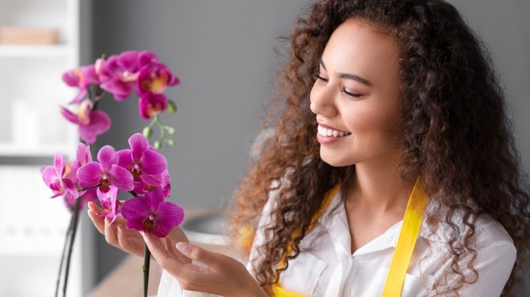 Woman tending to orchid