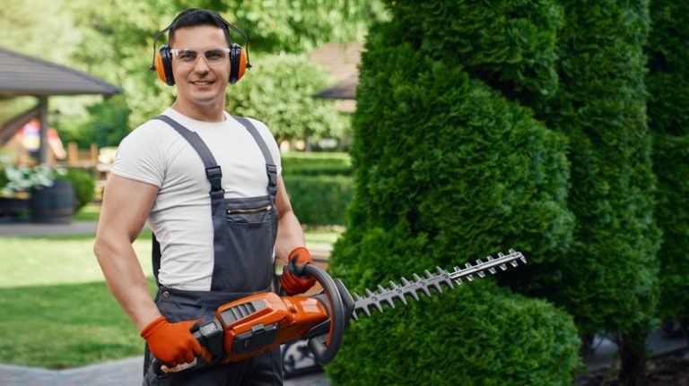 man holding hedge trimmer