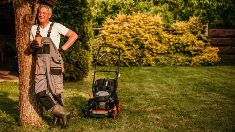 Man standing near lawnmower