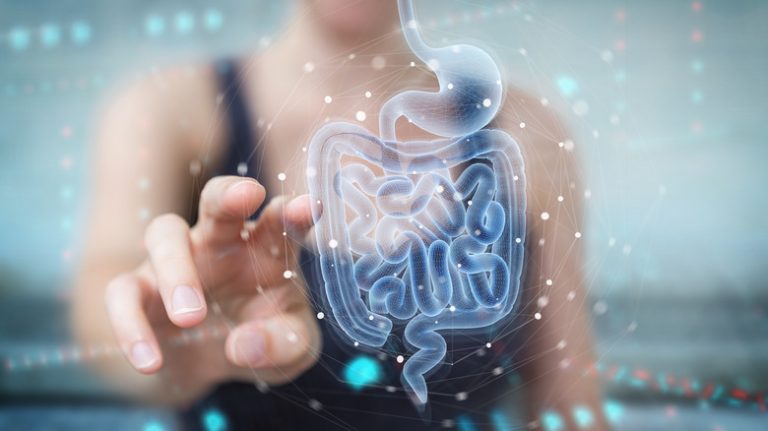 Woman on blurred background pointing to digital x-ray of human intestine holographic scan