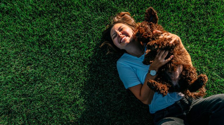 woman playing with dog