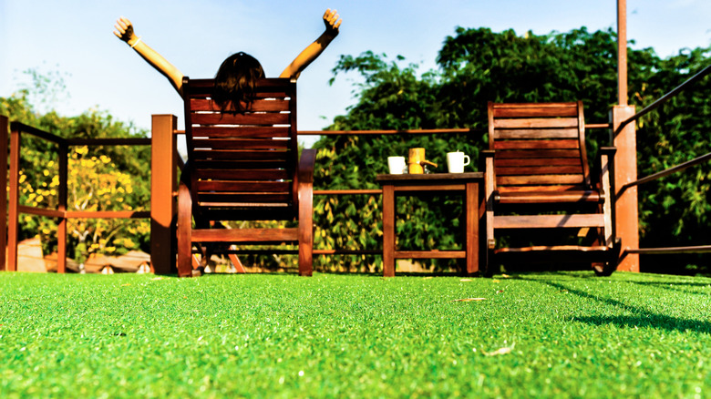 woman in artificial grass yard