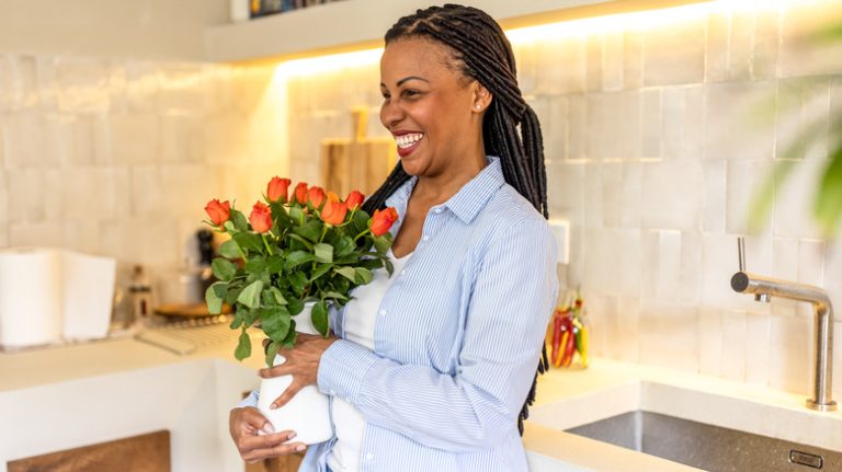 woman holding vase with flowers