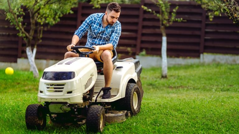 Man using riding lawn mower