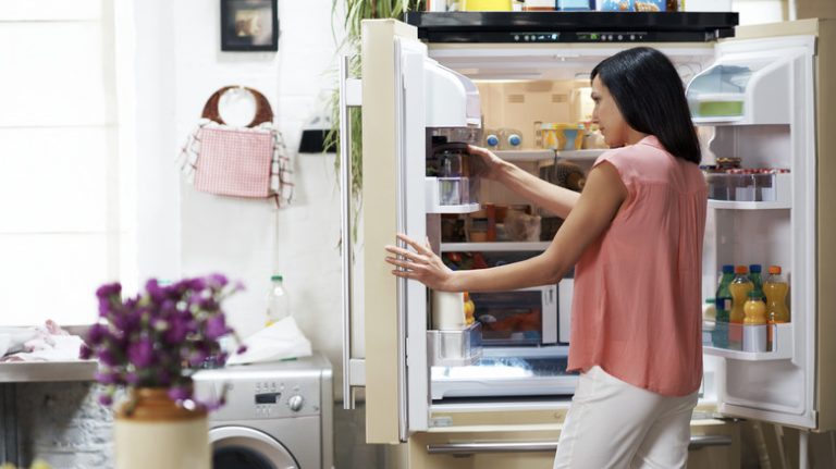 Woman looking through refrigerator