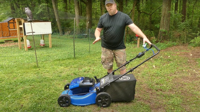 man using Kobalt battery mower