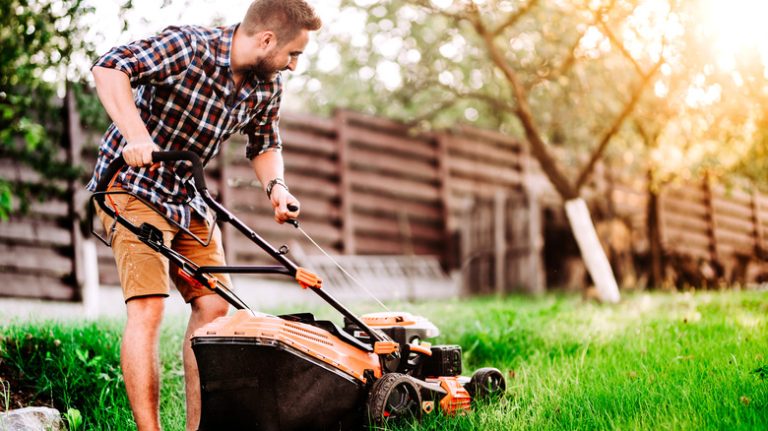 man starting lawnmower