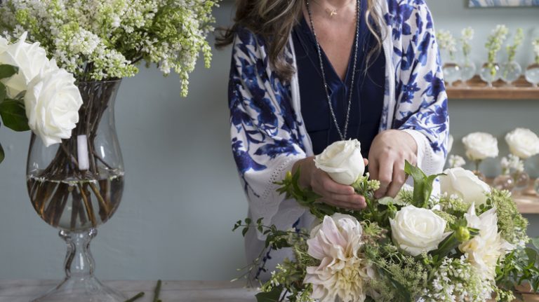 Woman arranging flowers in a vase