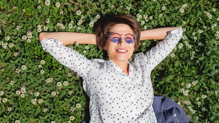 Woman relaxing on clover lawn