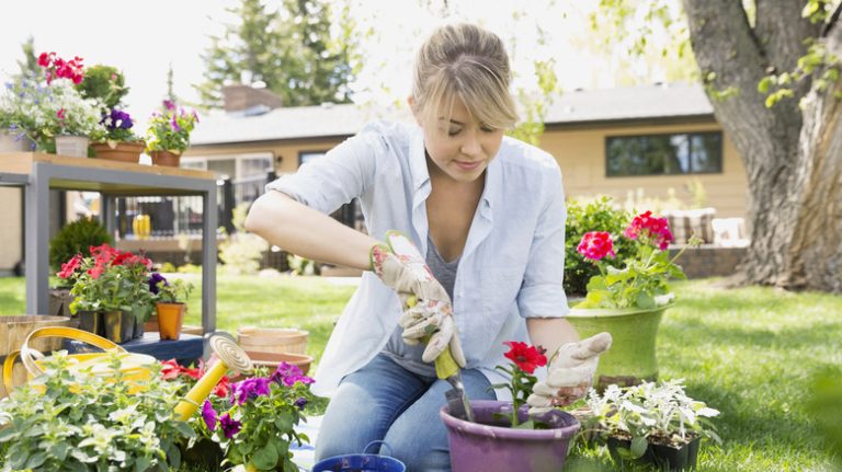 female gardener kneeling on grass