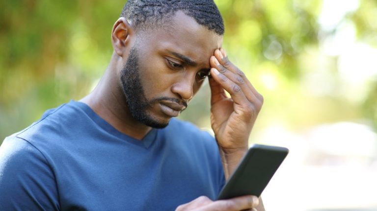 worried looking man on phone