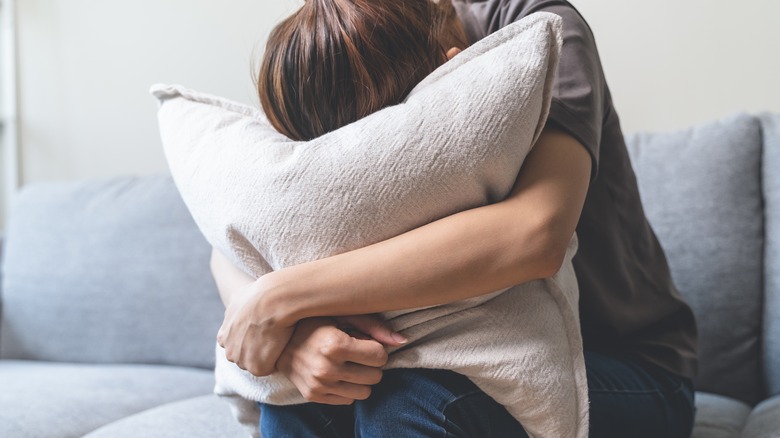 woman clutching pillow