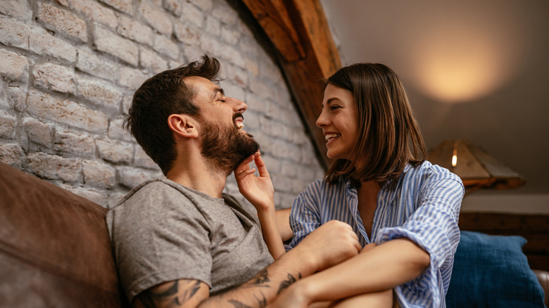 Woman touching man's beard