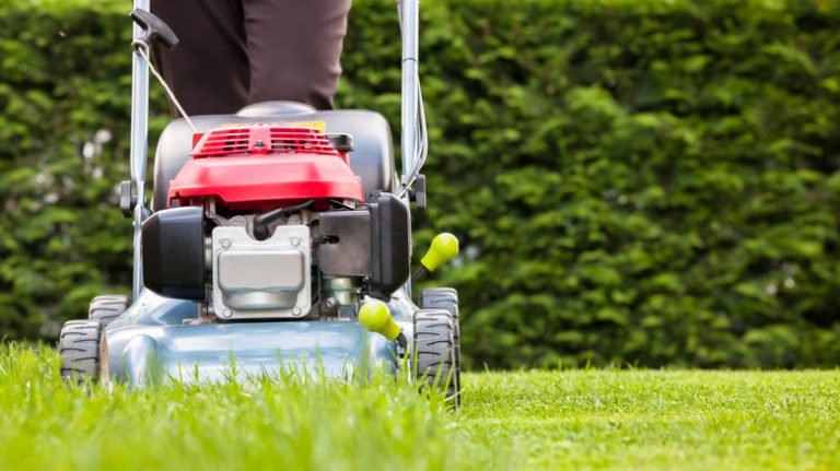 person mowing grass