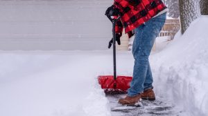 man shoveling a driveway