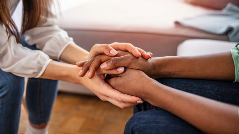 Two people holding hands