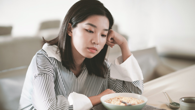 unhappy woman looking at food